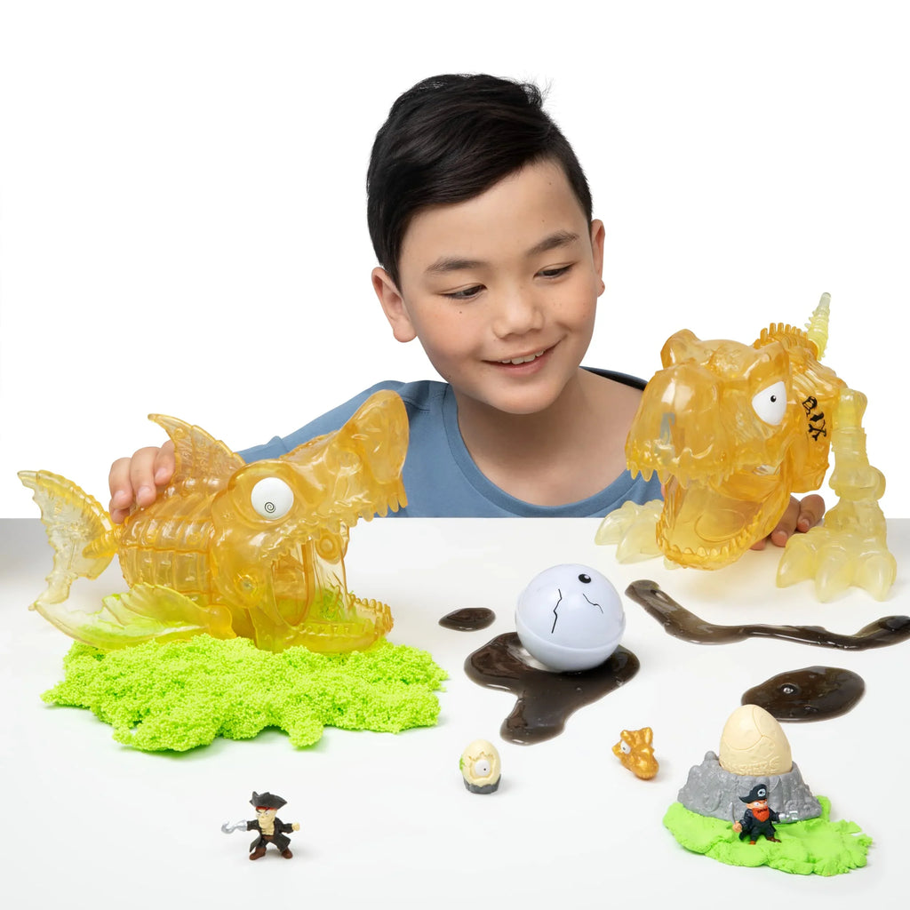 Island Discovery Toy, Smashers Skull Figurines, by Sand and Over 5+ Mini Slime, Dinosaur (T-Rex) 30 Giant ZURU Surprises, and Toys, with Eggs More Age Dino Prehistoric